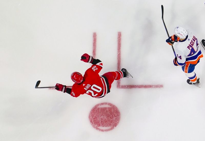 Dec 23, 2023; Raleigh, North Carolina, USA; Carolina Hurricanes center Sebastian Aho (20) celebrates his goal against the New York Islanders during the second period at PNC Arena. Mandatory Credit: James Guillory-USA TODAY Sports