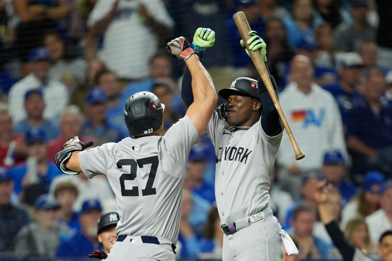 Oct 9, 2024; Kansas City, Missouri, USA; New York Yankees designated hitter Giancarlo Stanton (27) celebrates with New York Yankees third base Jazz Chisholm Jr. (13) after hitting a home run in the eighth inning against the Kansas City Royals during game three of the NLDS for the 2024 MLB Playoffs at Kauffman Stadium. Mandatory Credit: Jay Biggerstaff -Imagn Images
