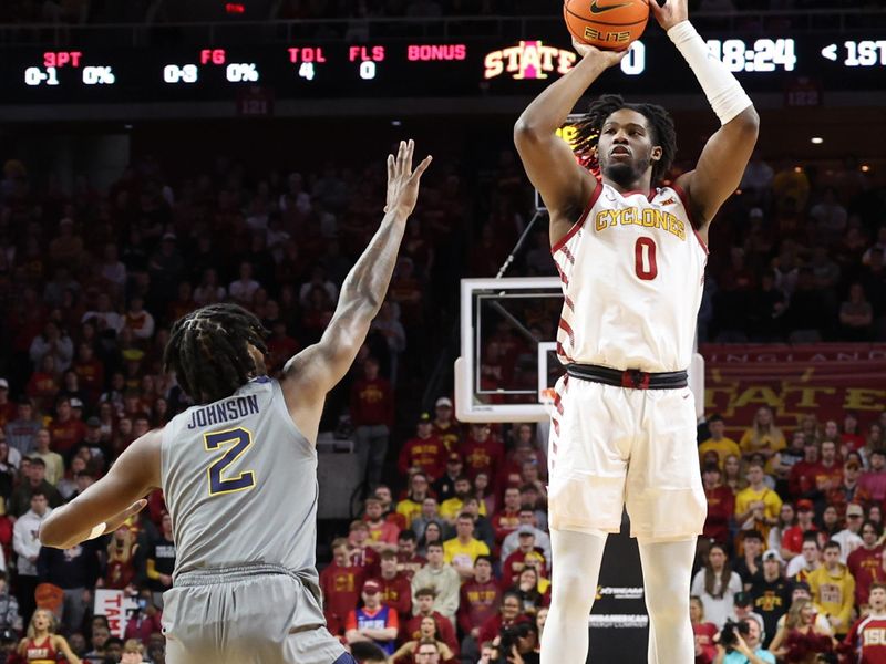 Feb 24, 2024; Ames, Iowa, USA; Iowa State Cyclones forward Tre King (0) shoots over West Virginia Mountaineers guard Kobe Johnson (2) during the first half at James H. Hilton Coliseum. Mandatory Credit: Reese Strickland-USA TODAY Sports