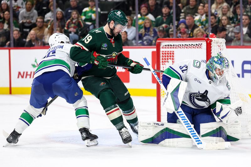 Dec 3, 2024; Saint Paul, Minnesota, USA; Vancouver Canucks goaltender Kevin Lankinen (32) makes a save against the Minnesota Wild during the second period at Xcel Energy Center. Mandatory Credit: Matt Krohn-Imagn Images