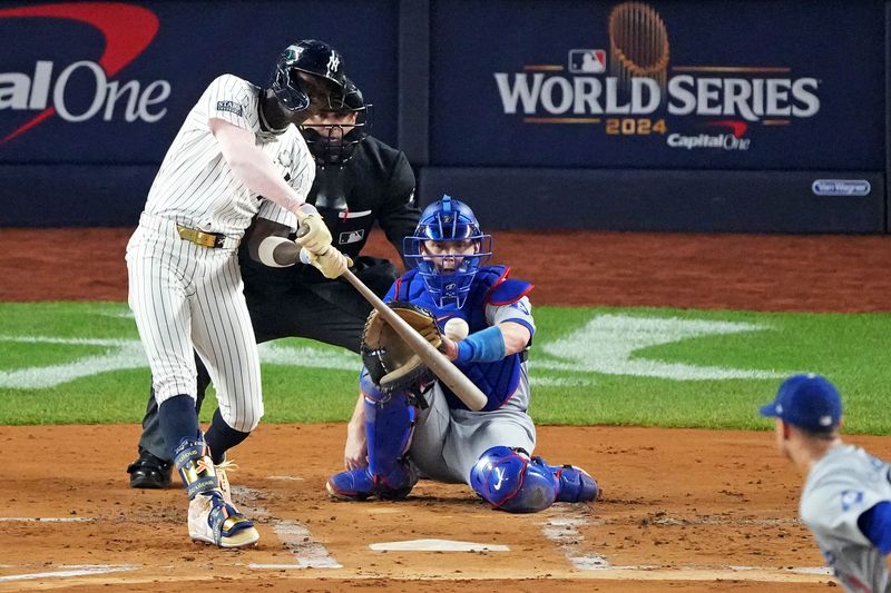 Oct 30, 2024; New York, New York, USA; New York Yankees third baseman Jazz Chisholm Jr. (13) hits a solo home run during the first inning against the Los Angeles Dodgers in game four of the 2024 MLB World Series at Yankee Stadium. Mandatory Credit: Robert Deutsch-Imagn Images