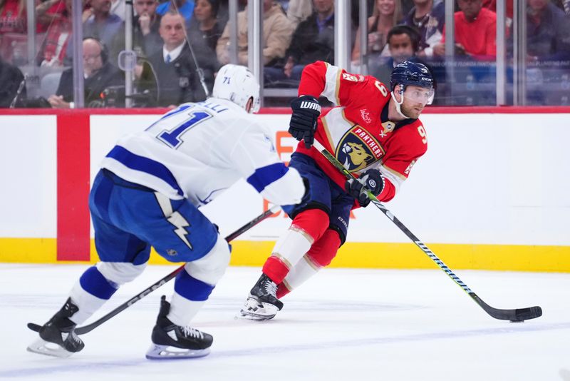 Apr 28, 2025; Sunrise, Florida, USA; Florida Panthers center Sam Bennett (9) controls the puck against Tampa Bay Lightning center Anthony Cirelli (71) during the first period in game four of the first round of the 2025 Stanley Cup Playoffs at Amerant Bank Arena. Mandatory Credit: Rich Storry-Imagn Images