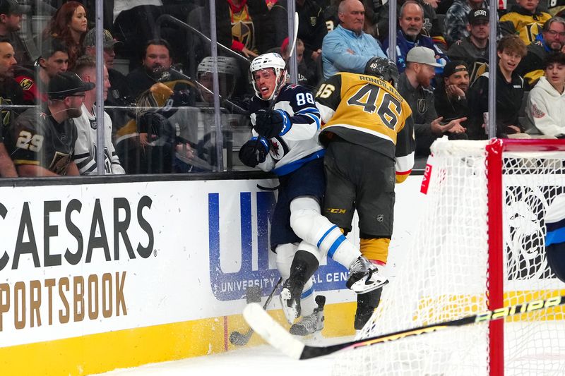 Nov 2, 2023; Las Vegas, Nevada, USA; Vegas Golden Knights right wing Jonas Rondbjerg (46) checks Winnipeg Jets defenseman Nate Schmidt (88) during the third period at T-Mobile Arena. Mandatory Credit: Stephen R. Sylvanie-USA TODAY Sports