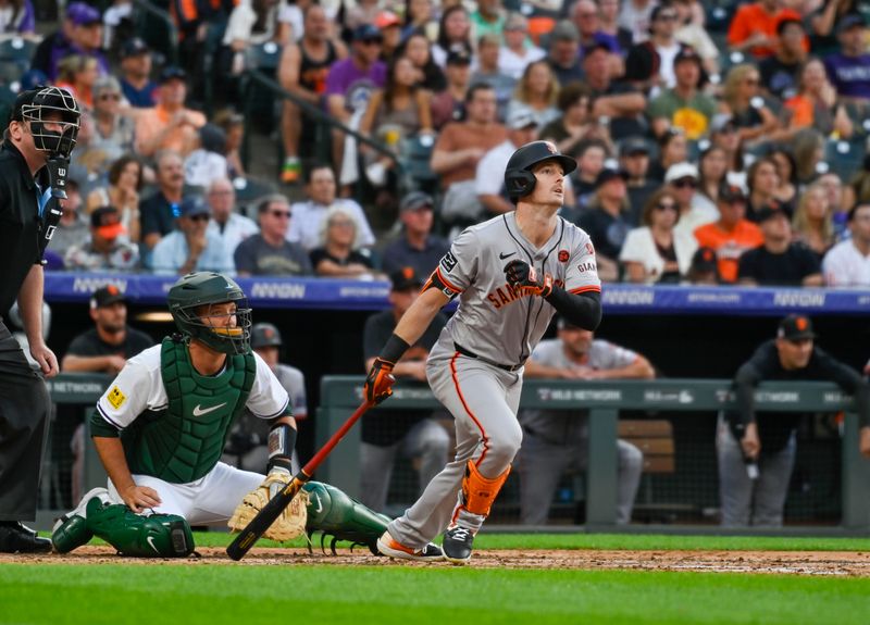 Jul 20, 2024; Denver, Colorado, USA; San Francisco Giants outfielder Mike Yastrzemski (5) hits a triple against the Colorado Rockies in the fifth inning at Coors Field. Mandatory Credit: John Leyba-USA TODAY Sports