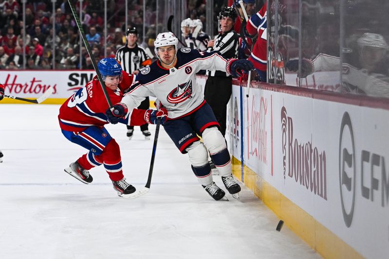 Nov 16, 2024; Montreal, Quebec, CAN; Columbus Blue Jackets center Cole Sillinger (4) plays the puck against Montreal Canadiens right wing Cole Caufield (13) along the boards  during the first period at Bell Centre. Mandatory Credit: David Kirouac-Imagn Images