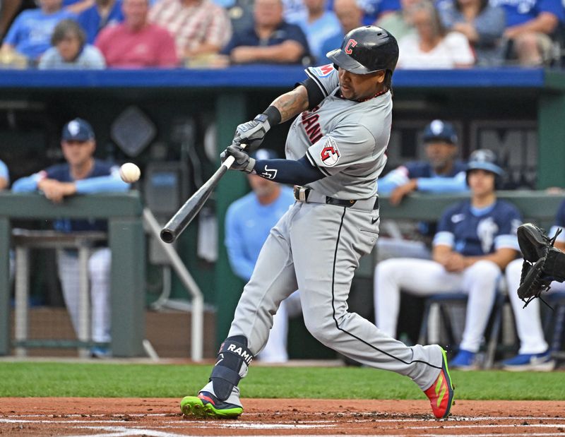Jun 28, 2024; Kansas City, Missouri, USA;  Cleveland Guardians third baseman Jose Ramirez (11) hits a solo home run in the first inning against the Kansas City Royals at Kauffman Stadium. Mandatory Credit: Peter Aiken-USA TODAY Sports