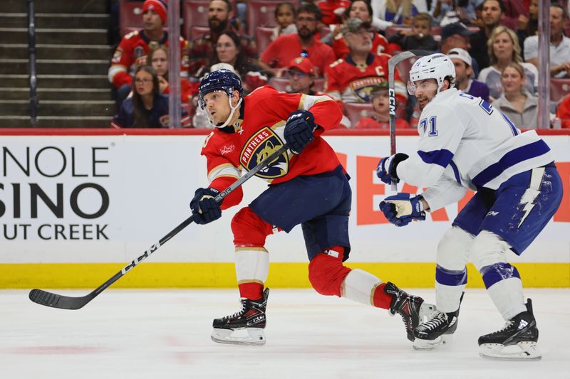 Apr 23, 2024; Sunrise, Florida, USA; Florida Panthers center Sam Reinhart (13) watches his shot against the Tampa Bay Lightning during the second period in game two of the first round of the 2024 Stanley Cup Playoffs at Amerant Bank Arena. Mandatory Credit: Sam Navarro-USA TODAY Sports