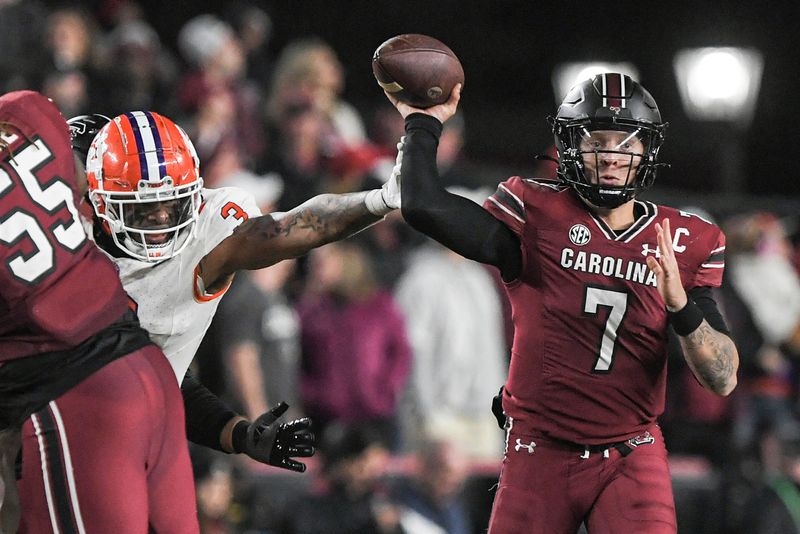 Nov 25, 2023; Columbia, South Carolina, USA; Clemson Tigers defensive end Xavier Thomas (3) breaks up a pass by South Carolina Gamecocks quarterback Spencer Rattler (7) during the second quarter at Williams-Brice Stadium. Mandatory Credit: Ken Ruinard-USA TODAY Sports