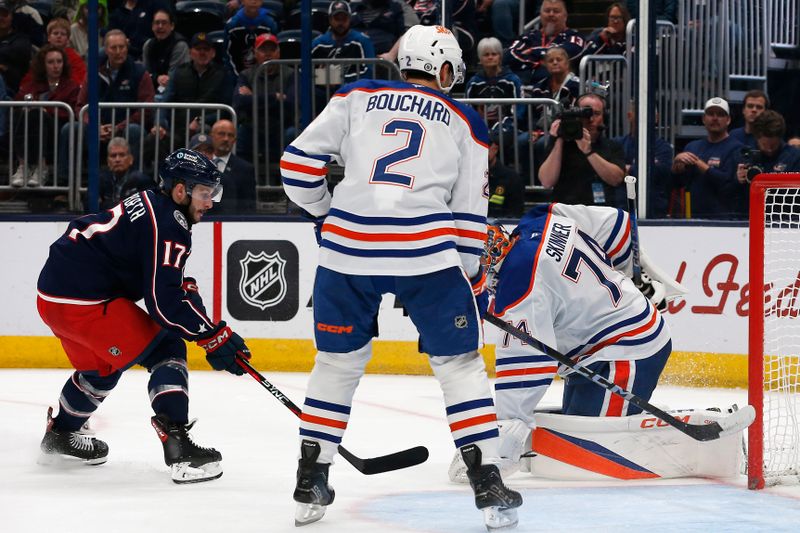 Oct 28, 2024; Columbus, Ohio, USA; Edmonton Oilers goalie Stuart Skinner (74) makes a save as Columbus Blue Jackets right wing Justin Danforth (17) looks for a rebound during the second period at Nationwide Arena. Mandatory Credit: Russell LaBounty-Imagn Images