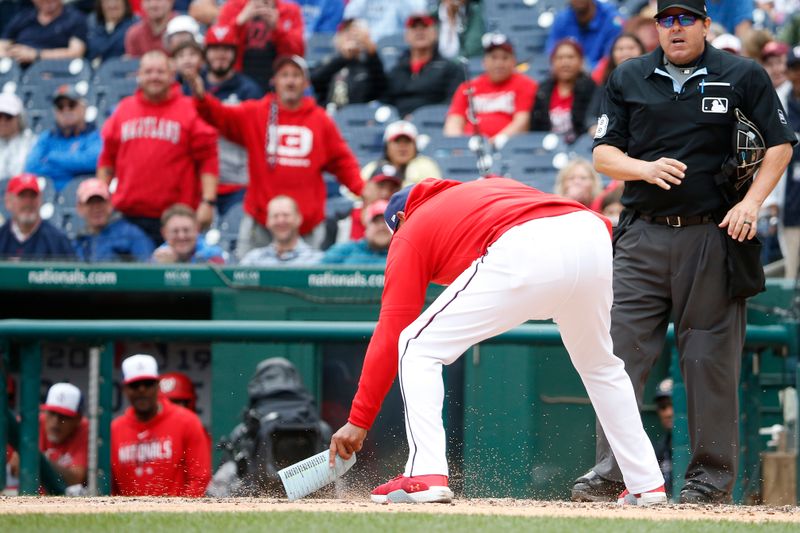 Jun 22, 2023; Washington, District of Columbia, USA; Washington Nationals manager Dave Martinez (center) cleans home plate after being ejected during the fifth inning against the Arizona Diamondbacks at Nationals Park. Mandatory Credit: Amber Searls-USA TODAY Sports