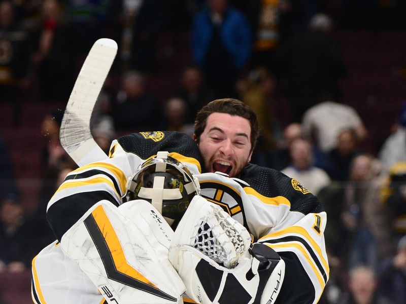 Feb 25, 2023; Vancouver, British Columbia, CAN; Boston Bruins goaltender Linus Ullmark (35) celebrates the win with goaltender Jeremy Swayman (1) after the third period at Rogers Arena. Mandatory Credit: Anne-Marie Sorvin-USA TODAY Sports