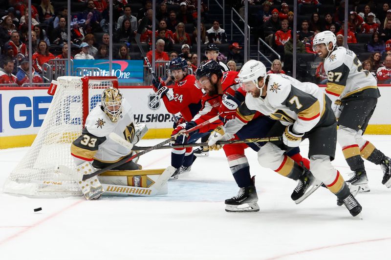 Oct 15, 2024; Washington, District of Columbia, USA; Washington Capitals right wing Tom Wilson (43) and Vegas Golden Knights defenseman Alex Pietrangelo (7) battle for the puck in front of Golden Knights goaltender Adin Hill (33) in the third period at Capital One Arena. Mandatory Credit: Geoff Burke-Imagn Images