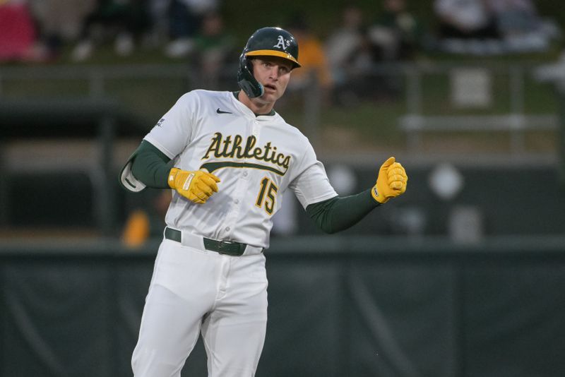 Apr 24, 2025; West Sacramento, California, USA; Athletics outfielder Seth Brown (15) motions to his team mates after hitting a double against the Texas Rangers during the second inning at Sutter Health Park. Mandatory Credit: Ed Szczepanski-Imagn Images