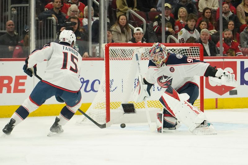 Dec 1, 2024; Chicago, Illinois, USA; Columbus Blue Jackets goaltender Elvis Merzlikins (90) clears the puck against the Chicago Blackhawks during the first period at United Center. Mandatory Credit: David Banks-Imagn Images