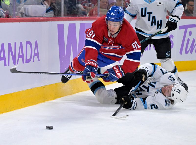 Nov 8, 2025; Montreal, Quebec, CAN; Montreal Canadiens forward Oliver Kapanen (91) trips over Utah Mammoth forward Barrett Hayton (27) during the second period at the Bell Centre. Mandatory Credit: Eric Bolte-Imagn Images
