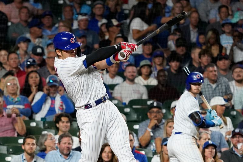 Jul 18, 2023; Chicago, Illinois, USA; Chicago Cubs right fielder Seiya Suzuki (27) hits a one run single against the Washington Nationals during the seventh inning at Wrigley Field. Mandatory Credit: David Banks-USA TODAY Sports