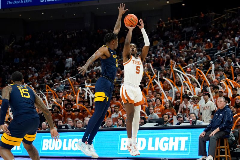 Feb 11, 2023; Austin, Texas, USA; Texas Longhorns guard Marcus Carr (5) shoots over West Virginia Mountaineers guard Kedrian Johnson (0) during the first half at Moody Center. Mandatory Credit: Scott Wachter-USA TODAY Sports ac