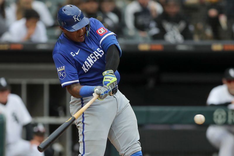 Apr 17, 2024; Chicago, Illinois, USA; Kansas City Royals catcher Salvador Perez (13) hits a two-run home run in the eight inning during game one of a double header against the Chicago White Sox at Guaranteed Rate Field. Mandatory Credit: Melissa Tamez-USA TODAY Sports