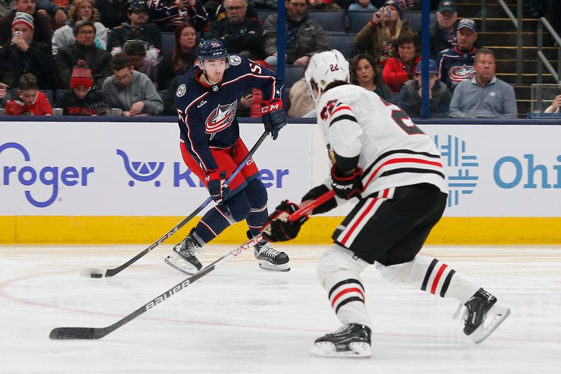 Nov 22, 2023; Columbus, Ohio, USA; Columbus Blue Jackets defenseman David Jiricek (55) shoots on goal as Chicago Blackhawks defenseman Nikita Zaitsev (22) defends during the third period at Nationwide Arena. Mandatory Credit: Russell LaBounty-USA TODAY Sports