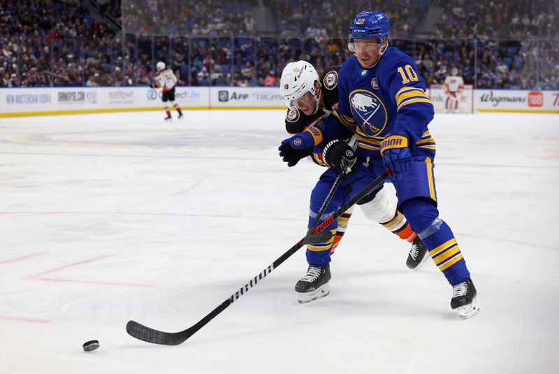 Feb 19, 2024; Buffalo, New York, USA;  Anaheim Ducks right wing Troy Terry (19) and Buffalo Sabres defenseman Henri Jokiharju (10) go after a loose puck during the third period at KeyBank Center. Mandatory Credit: Timothy T. Ludwig-USA TODAY Sports