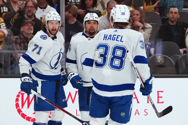 Mar 19, 2024; Las Vegas, Nevada, USA; Tampa Bay Lightning center Anthony Cirelli (71) celebrates with Tampa Bay Lightning defenseman Matt Dumba (24) and Tampa Bay Lightning left wing Brandon Hagel (38) after scoring a goal against the Vegas Golden Knights at T-Mobile Arena. Mandatory Credit: Stephen R. Sylvanie-USA TODAY Sports