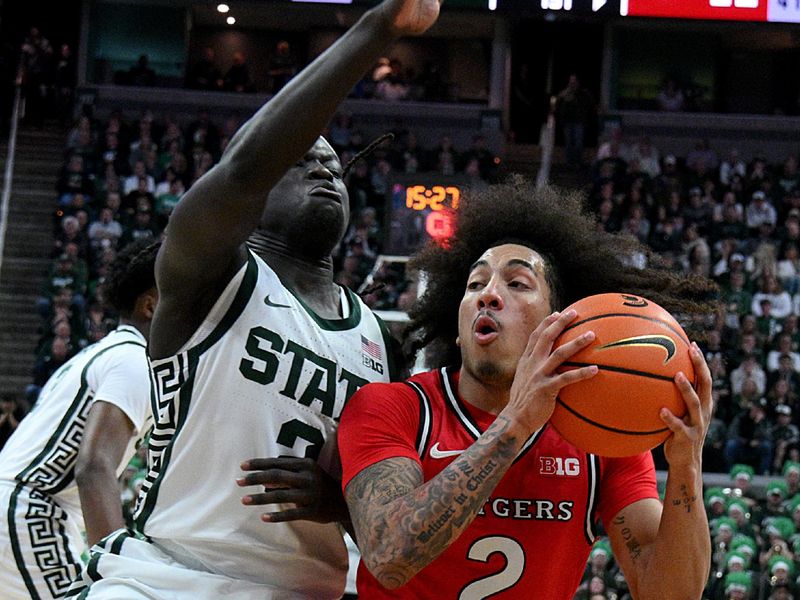 Mar 5, 2026; East Lansing, Michigan, USA;  Michigan State Spartans guard Kur Teng (2) blocks Rutgers Scarlet Knights guard Lino Mark (2) way to the basket during the first half at Jack Breslin Student Events Center. Mandatory Credit: Dale Young-Imagn Images