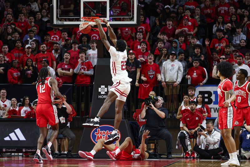 Mar 10, 2024; Piscataway, New Jersey, USA; Rutgers Scarlet Knights center Emmanuel Ogbole (22) dunks the ball in front of Ohio State Buckeyes guard Evan Mahaffey (12) during the first half at Jersey Mike's Arena. Mandatory Credit: Vincent Carchietta-USA TODAY Sports