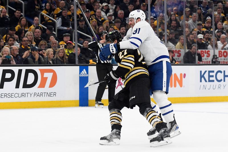 Apr 30, 2024; Boston, Massachusetts, USA; Toronto Maple Leafs center John Tavares (91) grabs a hold of Boston Bruins defenseman Hampus Lindholm (27) during the second period in game five of the first round of the 2024 Stanley Cup Playoffs at TD Garden. Mandatory Credit: Bob DeChiara-USA TODAY Sports