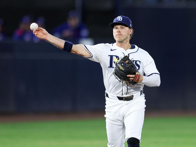 Jun 3, 2025; Tampa, Florida, USA; Tampa Bay Rays shortstop Taylor Walls (6) throws two first base for an out against the Texas Rangers in the second inning at George M. Steinbrenner Field. Mandatory Credit: Nathan Ray Seebeck-Imagn Images