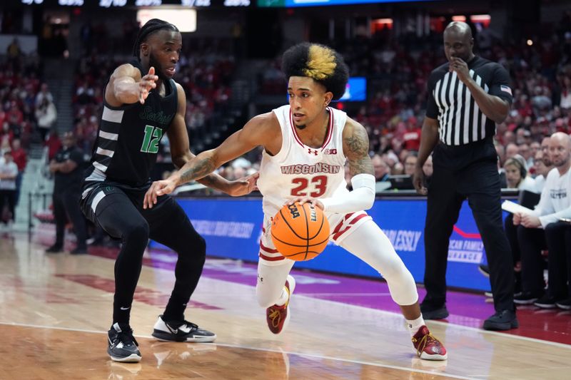 Dec 22, 2023; Madison, Wisconsin, USA; Wisconsin Badgers guard Chucky Hepburn (23) dribbles the ball against Chicago State Cougars guard Brent Davis (12) during the second half at the Kohl Center. Mandatory Credit: Kayla Wolf-USA TODAY Sports