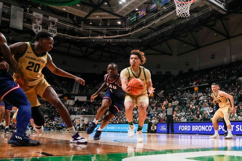 Jan 6, 2024; Charlotte, North Carolina, USA; Charlotte 49ers guard Lu'Cye Patterson (25) tries to hold onto the rebound heading out of bounds and passing to forward Robert Braswell IV (20) defended by Florida Atlantic Owls guard Johnell Davis (1) during the second half at Dale F. Halton Arena. Mandatory Credit: Jim Dedmon-USA TODAY Sports