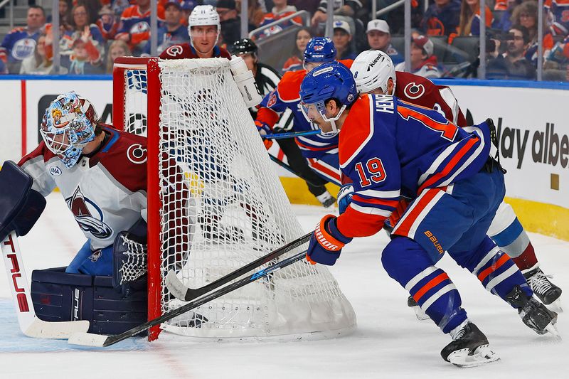 Nov 8, 2025; Edmonton, Alberta, CAN; Edmonton Oilers forward Adam Henrique (19) tries to jam a puck past Colorado Avalanche goaltender Scott Wedgewood (41) during the first period at Rogers Place. Mandatory Credit: Perry Nelson-Imagn Images