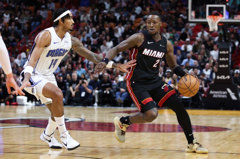 MIAMI, FLORIDA - FEBRUARY 06: Terry Rozier #2 of the Miami Heat drives against Gary Harris #14 of the Orlando Magic during the fourth quarter at Kaseya Center on February 06, 2024 in Miami, Florida. NOTE TO USER: User expressly acknowledges and agrees that, by downloading and or using this photograph, User is consenting to the terms and conditions of the Getty Images License Agreement. (Photo by Megan Briggs/Getty Images)