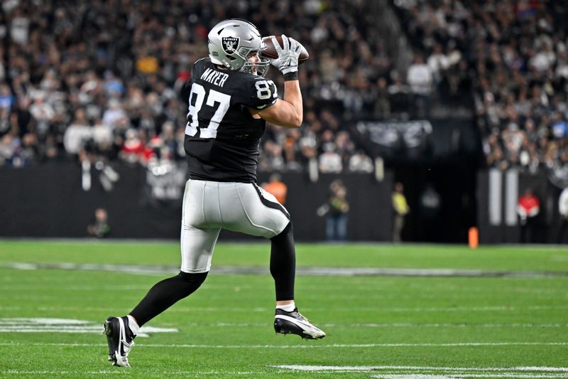 Las Vegas Raiders tight end Michael Mayer (87) makes a catch against the Los Angeles Chargers during the first half of an NFL football game, Thursday, Dec. 14, 2023, in Las Vegas. (AP Photo/David Becker)