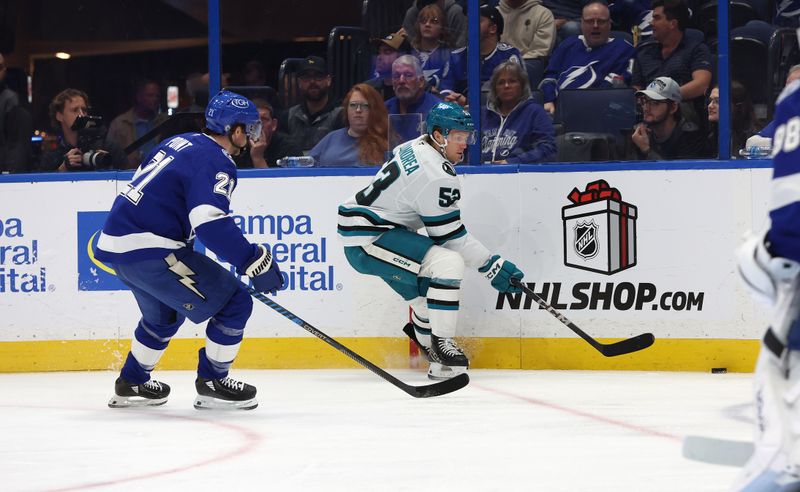 Dec 5, 2024; Tampa, Florida, USA; San Jose Sharks center Ty Dellandrea (53) skates with the puck as Tampa Bay Lightning center Brayden Point (21) defends during the second period at Amalie Arena. Mandatory Credit: Kim Klement Neitzel-Imagn Images