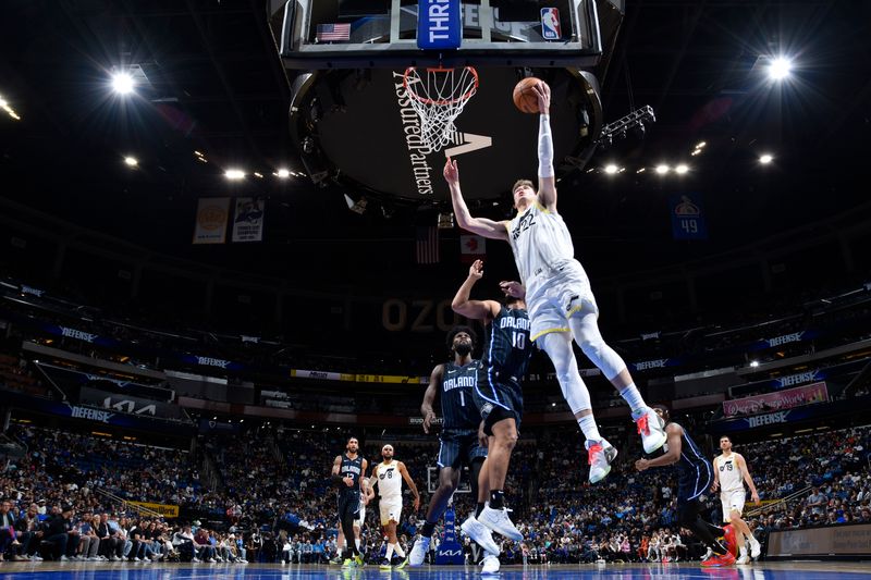 ORLANDO, FL - JANUARY 5 :  Kyle Filipowski #22 of the Utah Jazz drives to the basket during the game against the Orlando Magic on January 5, 2025 at Kia Center in Orlando, Florida. NOTE TO USER: User expressly acknowledges and agrees that, by downloading and or using this photograph, User is consenting to the terms and conditions of the Getty Images License Agreement. Mandatory Copyright Notice: Copyright 2025 NBAE (Photo by Fernando Medina/NBAE via Getty Images)