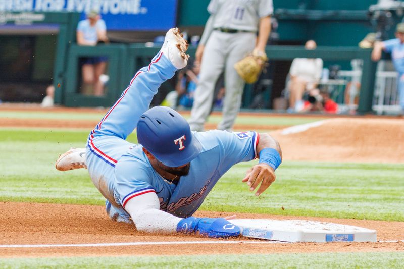 May 21, 2023; Arlington, Texas, USA; Texas Rangers shortstop Ezequiel Duran (20) slides into third base during the second inning against the Colorado Rockies at Globe Life Field. Mandatory Credit: Andrew Dieb-USA TODAY Sports