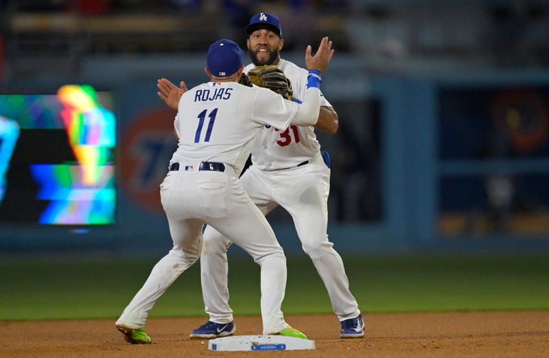 Aug 16, 2023; Los Angeles, California, USA;  Los Angeles Dodgers shortstop Miguel Rojas (11) and second baseman Amed Rosario (31) celebrate after the final out of the ninth inning against the Milwaukee Brewers at Dodger Stadium. Mandatory Credit: Jayne Kamin-Oncea-USA TODAY Sports