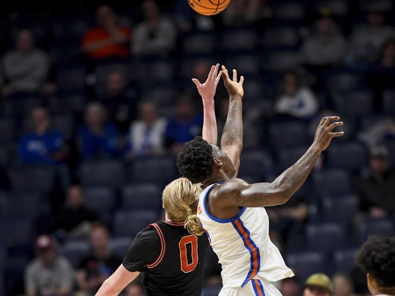 Mar 14, 2024; Nashville, TN, USA;  Florida Gators forward Tyrese Samuel (4) and Georgia Bulldogs guard Blue Cain (0) fight for the loose ball during the second half at Bridgestone Arena. Mandatory Credit: Steve Roberts-USA TODAY Sports