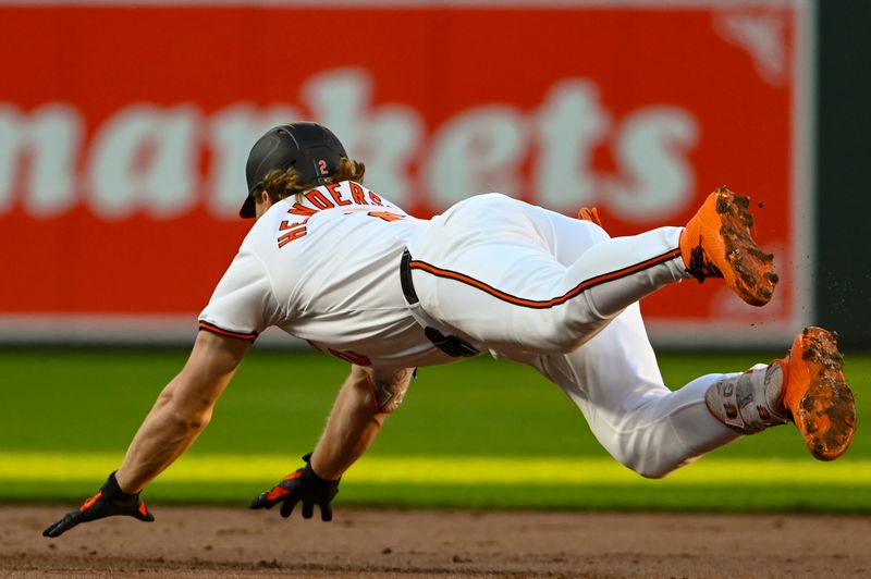 Sep 3, 2024; Baltimore, Maryland, USA;  Baltimore Orioles shortstop Gunnar Henderson (2) divers into second base for a first inning double against the Chicago White Sox at Oriole Park at Camden Yards. Mandatory Credit: Tommy Gilligan-Imagn Images