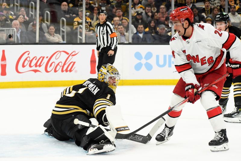 Apr 9, 2024; Boston, Massachusetts, USA; Boston Bruins goaltender Jeremy Swayman (1) makes a save on Carolina Hurricanes center Seth Jarvis (24) during the second period at TD Garden. Mandatory Credit: Bob DeChiara-USA TODAY Sports