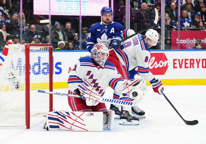 Dec 19, 2023; Toronto, Ontario, CAN; Toronto Maple Leafs center Auston Matthews (34) battles for the puck with New York Rangers defenseman Jacob Trouba (8) in front of goaltender Igor Shesterkin (31) during the third period at Scotiabank Arena. Mandatory Credit: Nick Turchiaro-USA TODAY Sports