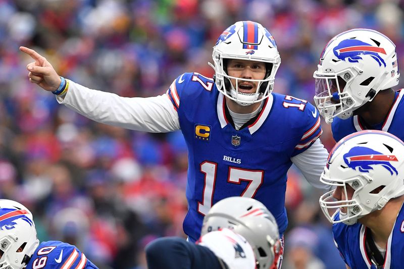 Buffalo Bills quarterback Josh Allen (17) calls signals during the first half of an NFL football game against the New England Patriots in Orchard Park, N.Y., Sunday, Dec. 31, 2023. (AP Photo/Adrian Kraus)wld