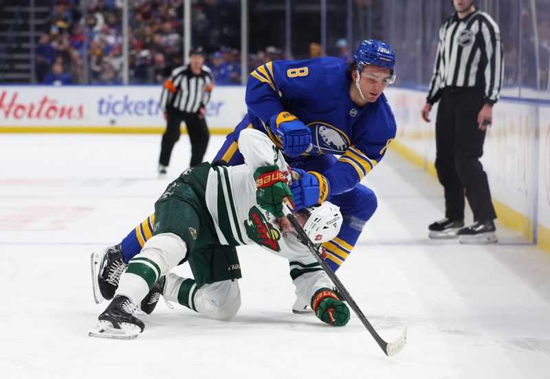 Jan 17, 2026; Buffalo, New York, USA;  Buffalo Sabres defenseman Michael Kesselring (8) knocks down Minnesota Wild defenseman Quinn Hughes (43) as he goes after a loose puck during the first period at KeyBank Center. Mandatory Credit: Timothy T. Ludwig-Imagn Images