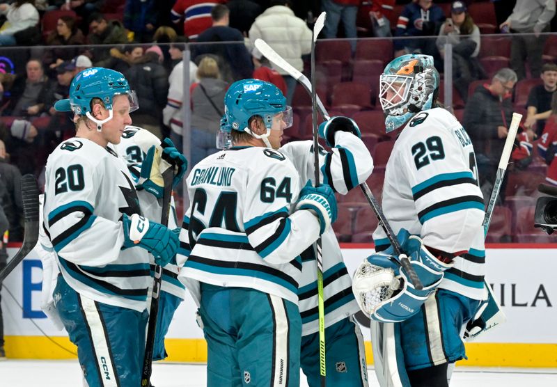 Jan 11, 2024; Montreal, Quebec, CAN; San Jose Sharks goalie Mackenzie Blackwood (29) celebrates with teammates forward Fabian Zetterlund (20) and forward Mikael Granlund (64)  the win against the Montreal Canadiens at the Bell Centre. Mandatory Credit: Eric Bolte-USA TODAY Sports