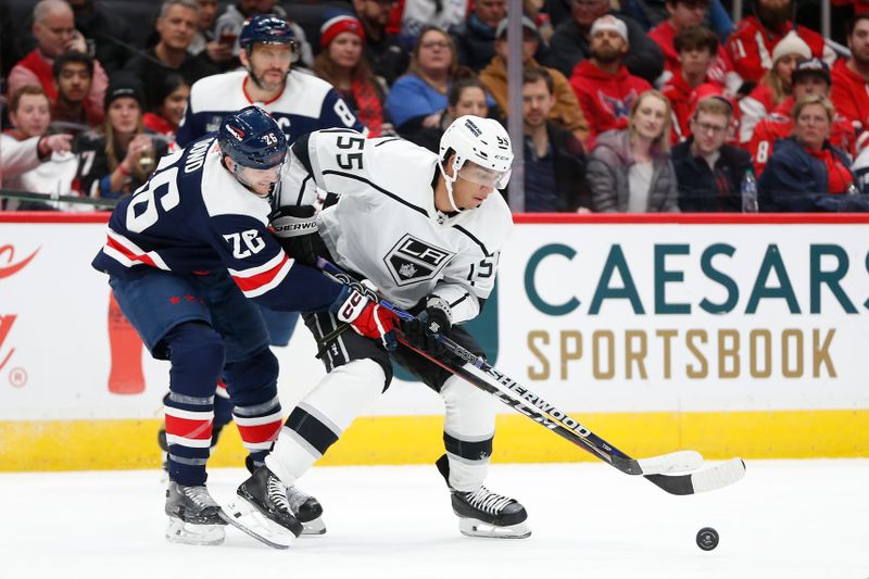 Jan 7, 2024; Washington, District of Columbia, USA; Los Angeles Kings right wing Quinton Byfield (55) battles for the puck with Washington Capitals right wing Nic Dowd (26) during the first period at Capital One Arena. Mandatory Credit: Amber Searls-USA TODAY Sports