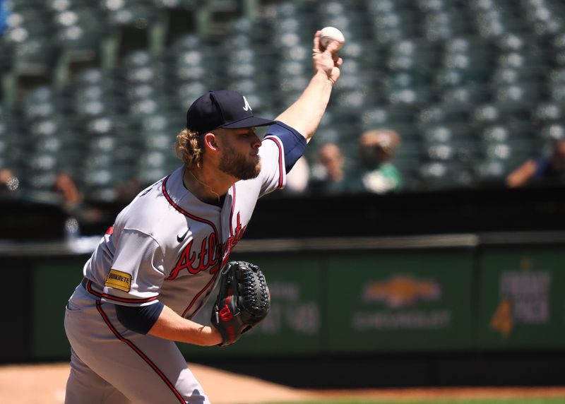 May 31, 2023; Oakland, California, USA; Atlanta Braves relief pitcher A.J. Minter (33) pitches the ball against the Oakland Athletics during the seventh inning at Oakland-Alameda County Coliseum. Mandatory Credit: Kelley L Cox-USA TODAY Sports