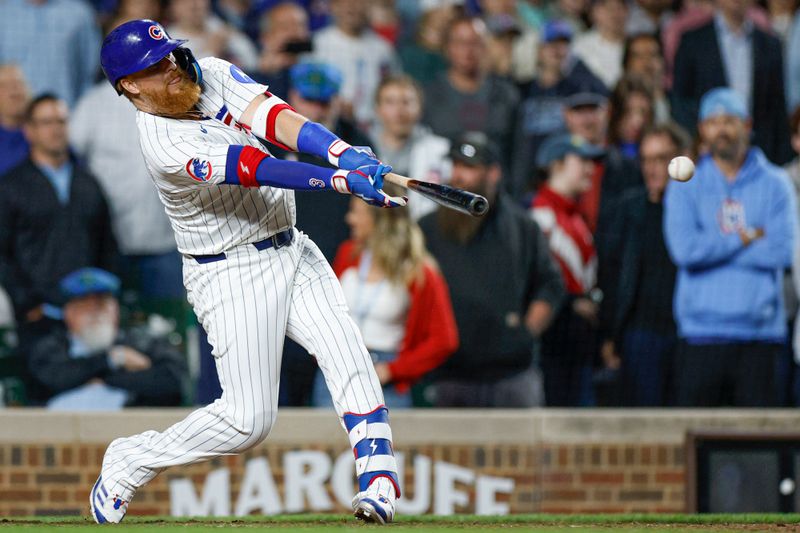 May 13, 2025; Chicago, Illinois, USA; Chicago Cubs first base Justin Turner (3) hits a walk-off two-run double against the Miami Marlins during the ninth inning at Wrigley Field. Mandatory Credit: Kamil Krzaczynski-Imagn Images