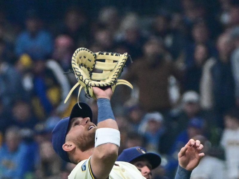 Apr 2, 2024; Milwaukee, Wisconsin, USA;  Milwaukee Brewers first baseman Jake Bauers (9) catches a popup hit by Minnesota Twins catcher Christian Vazquez (not pictured) in the third inning at American Family Field. Mandatory Credit: Benny Sieu-USA TODAY Sports
