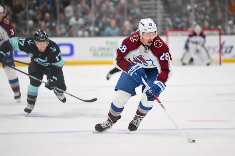 Nov 13, 2023; Seattle, Washington, USA; Colorado Avalanche left wing Miles Wood (28) advances the puck against the Seattle Kraken during the first period at Climate Pledge Arena. Mandatory Credit: Steven Bisig-USA TODAY Sports